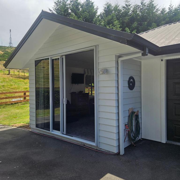 a screened in garage with a sliding glass door at Seventy-Four on Ramsay in Taupo