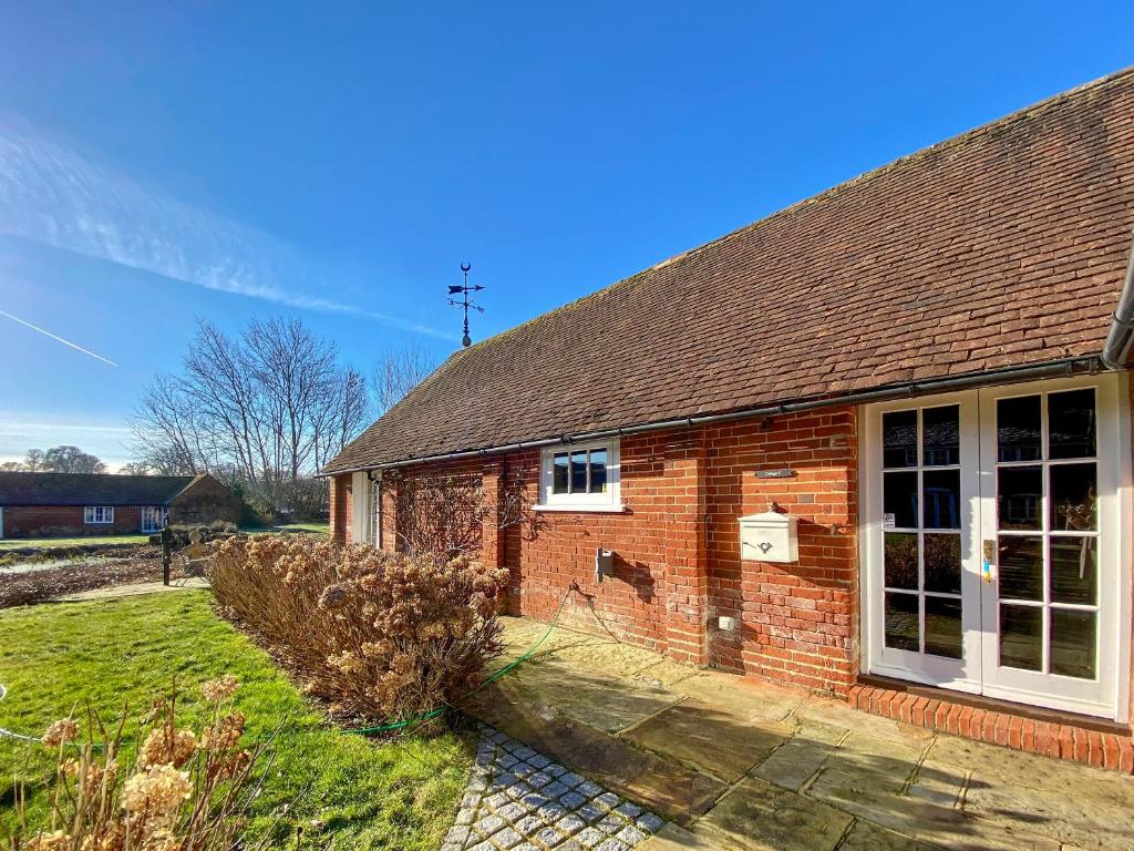 a brick house with a window and a roof at Oaklands Farm - Cottage 5 in Broughton