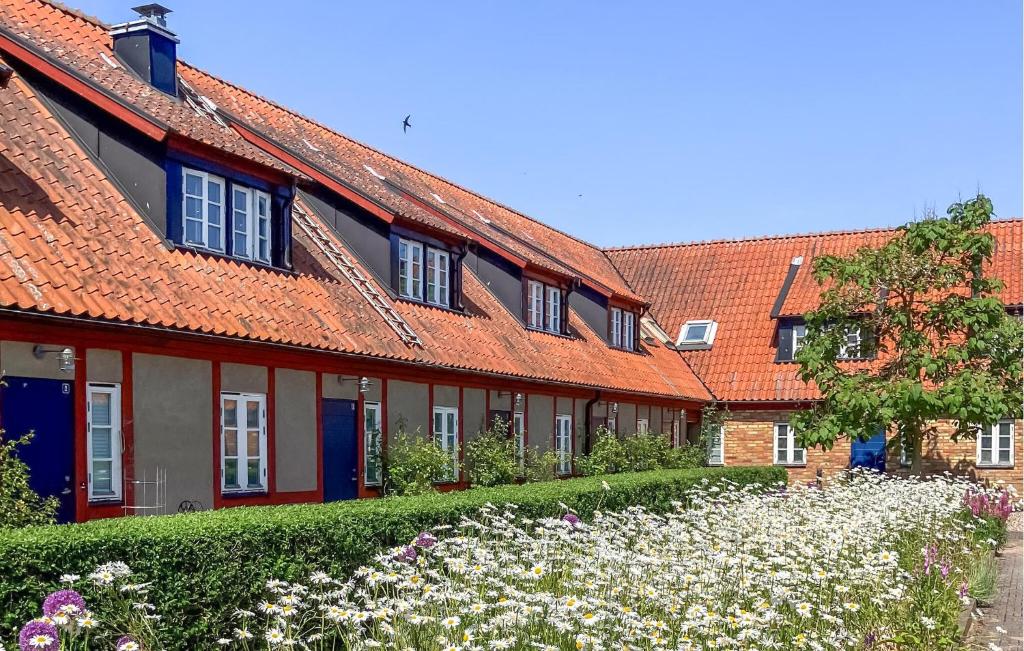 a row of houses with flowers in front of them at 3 Bedroom Beautiful Home In Simrishamn in Simrishamn