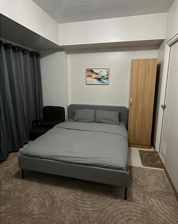 a bedroom with a bed in a room at MERE Suite Davao- One Lakeshore behind SM Lanang in Davao City