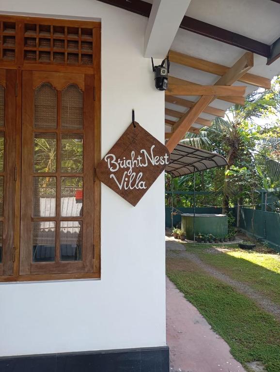 a sign on the side of a house at Bright Nest Villa in Matara
