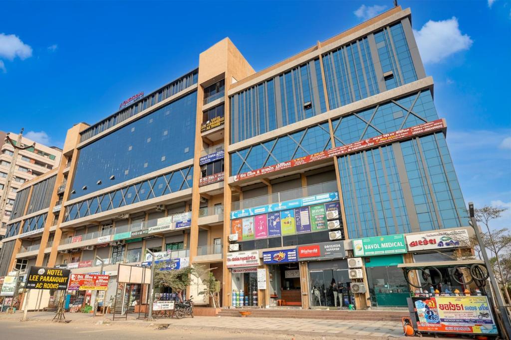 a large building with many windows on a street at Hotel Lee Paramount in Gandhinagar