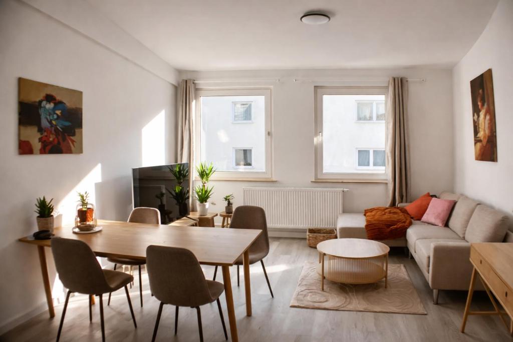 a living room with a table and a couch at Rue118 in Essen