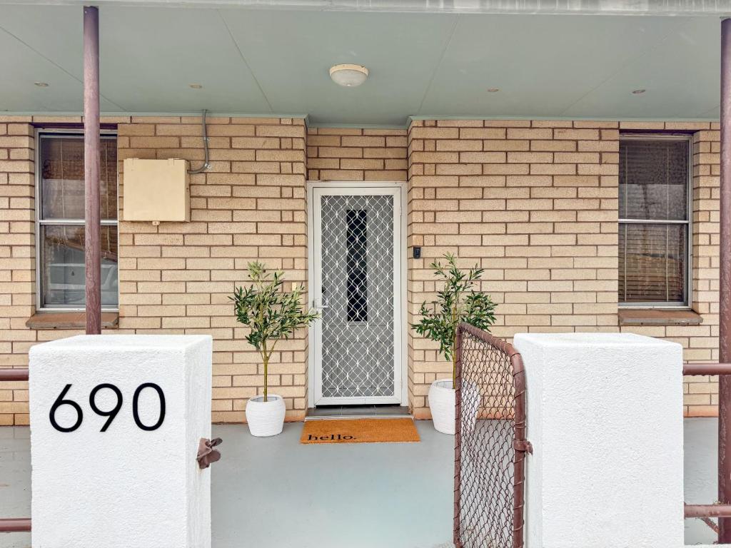 a front door of a house with a sign at Saltbush Cottage in Broken Hill