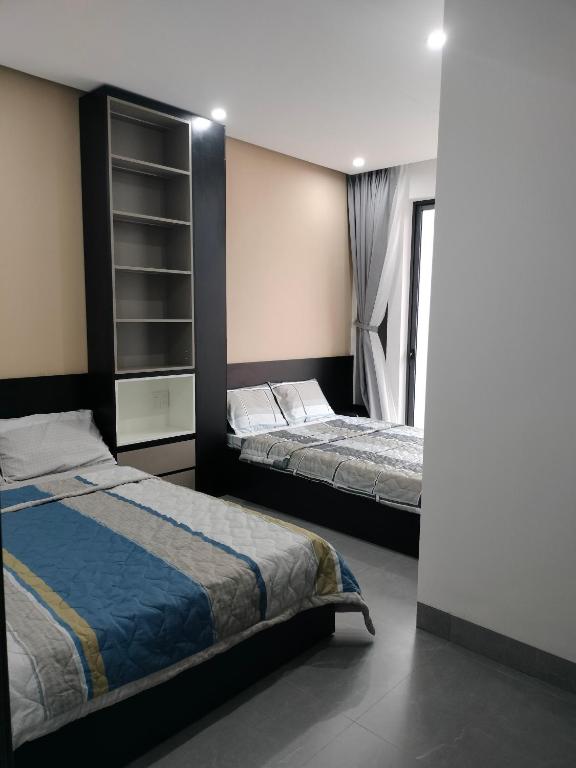 a bedroom with two beds in a room at Lien Home in Thôn An Hòa