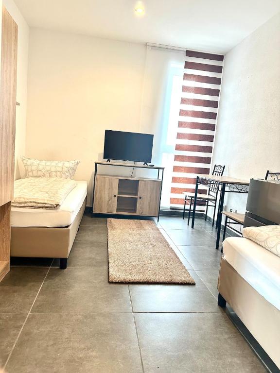 a living room with a couch and a tv at Three bedroom apartment in Dingolfing