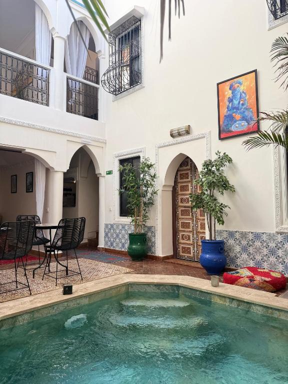 a swimming pool in the middle of a house at Riad FARASHA & Pool-Rooftop View in Marrakesh