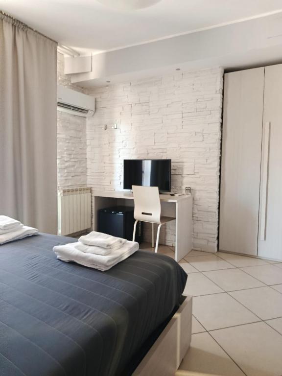 a bedroom with a bed and a desk with a computer at Central in Casarile