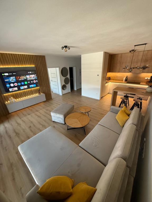 a living room with a large couch and a television at ApartmanBrezovina217 in Veselé