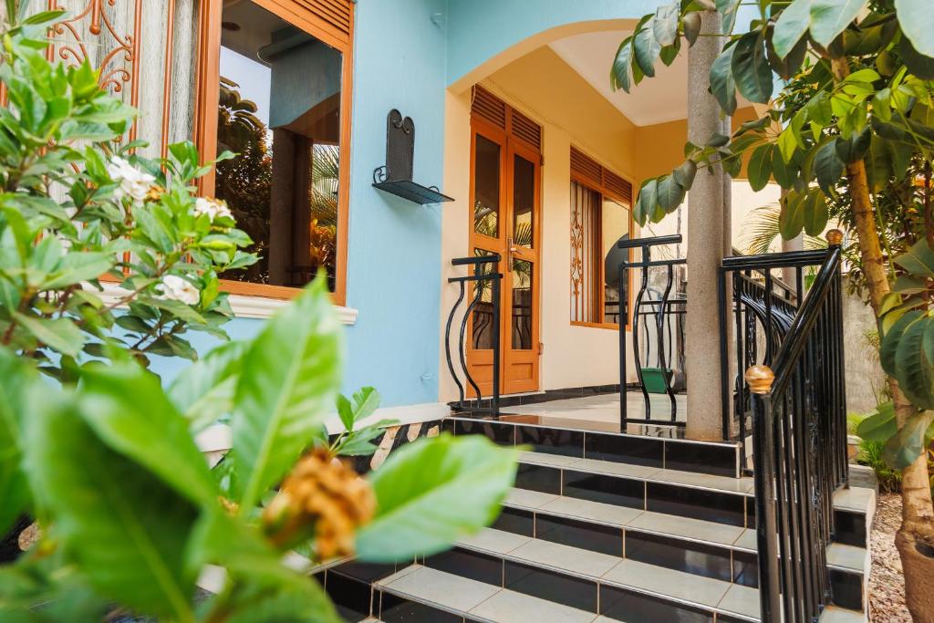 a house with stairs leading to the front door at Palm Haven Furnished Apartments in Bweyogerere