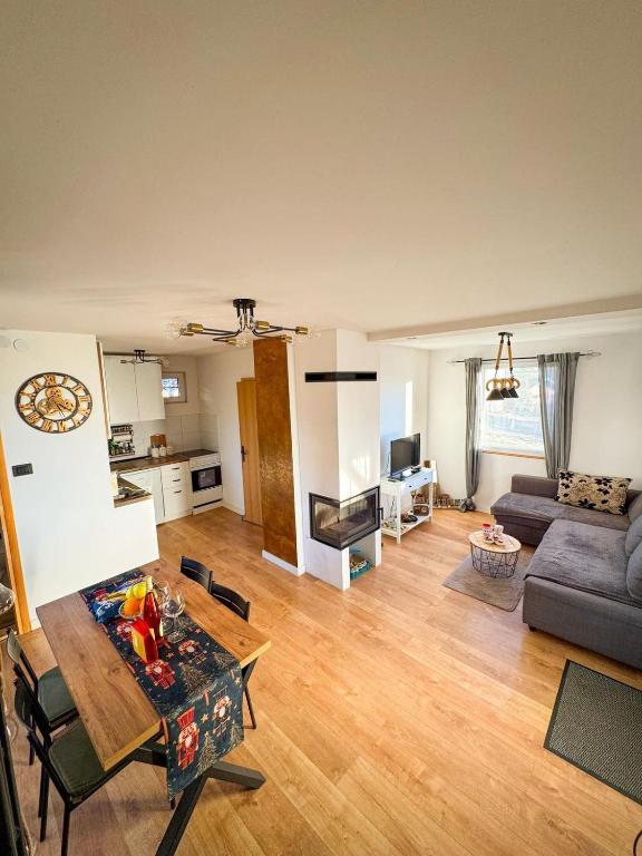 a living room with a table and a couch at Vila Xenos Loft Karakter Zlatibor in Zlatibor
