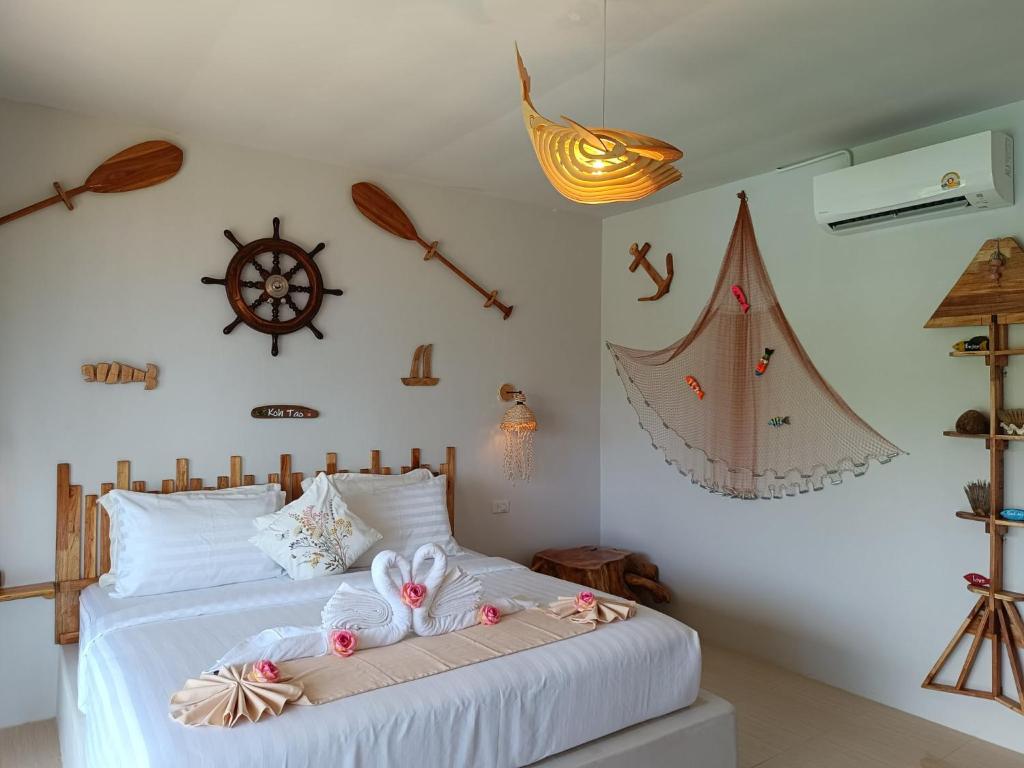 a bedroom with two beds with stuffed animals on them at Marine House Koh Tao in Ko Tao