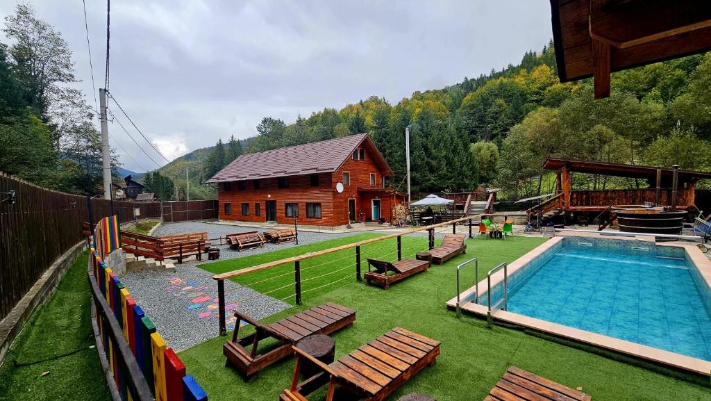 a house with a swimming pool next to a building at Cămăruța din Apuseni in Valea Ierii