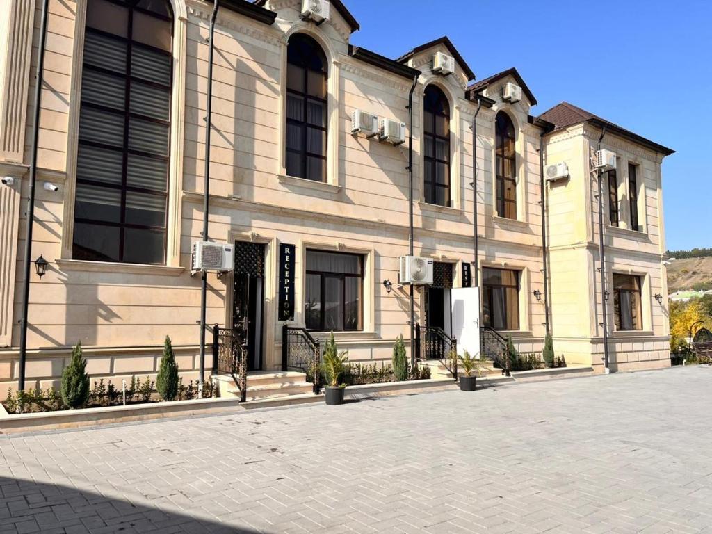 a large building on a street in front at River Hotel Restaurant in Quba