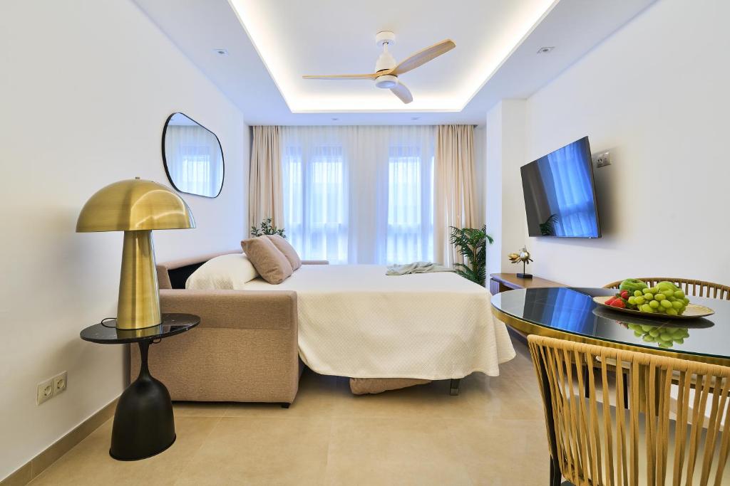 a hotel room with a bed and a table at Malagueta Loft & Sea in Málaga