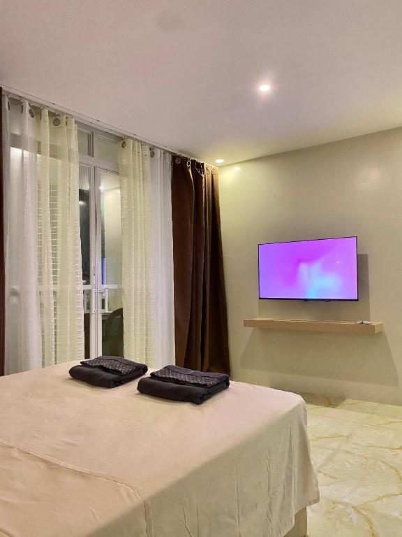 a room with a bed with two towels on it at Isla Haus Boracay in Boracay