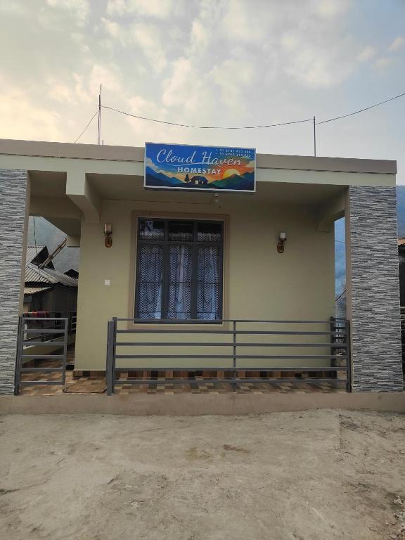 a building with a bench and a sign on it at Cloud Haven in Lāitlyngkot