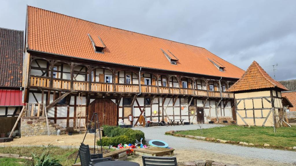 a large wooden building with an orange roof at Wippertaler Hütte in Kleinfurra