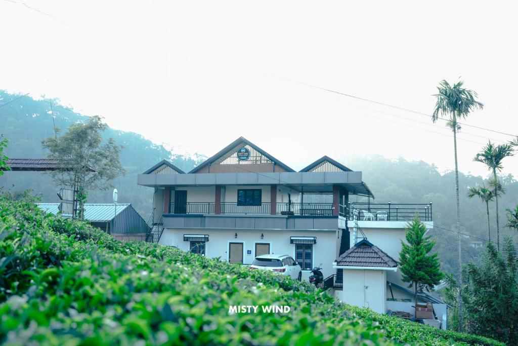 a house on top of a hill at Vythiri Misty Wind Holiday Homes in Vythiri