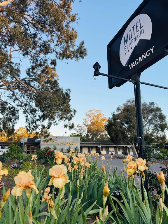 a sign for a walmart with flowers in the foreground at Motel St Arnaud in Saint Arnaud
