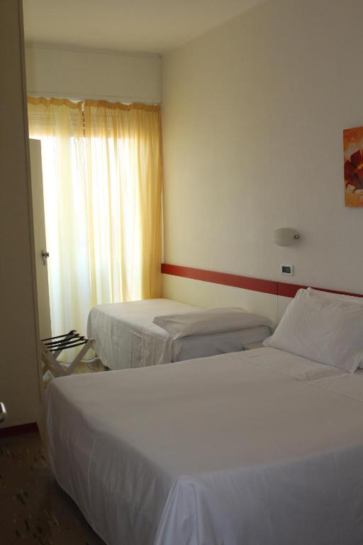 Postel nebo postele na pokoji v ubytování Hotel Universal