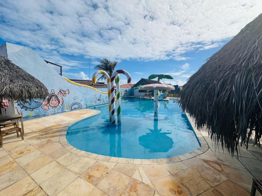 a pool with candy canes in the middle at Juscelino Pousada lazer in Tibau