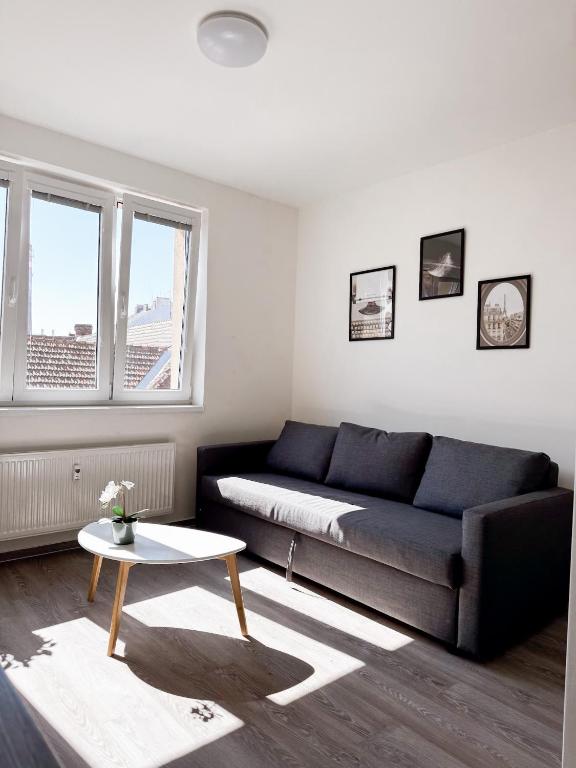 a living room with a couch and a table at District B Apartments in Brno