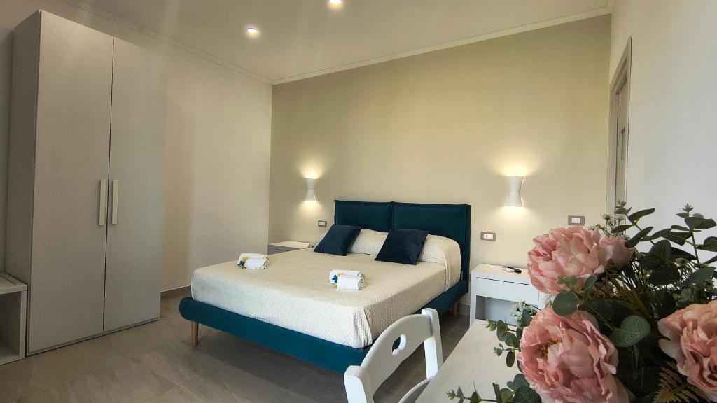 a bedroom with a bed and a table with flowers at Casa Michela in Sant'Agnello