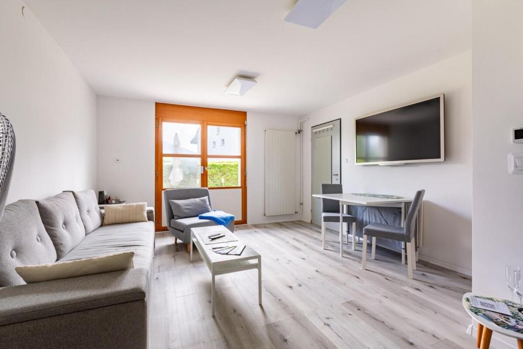 a living room with a couch and a table at Immensee Appartments by Mainka Properties in Immensee