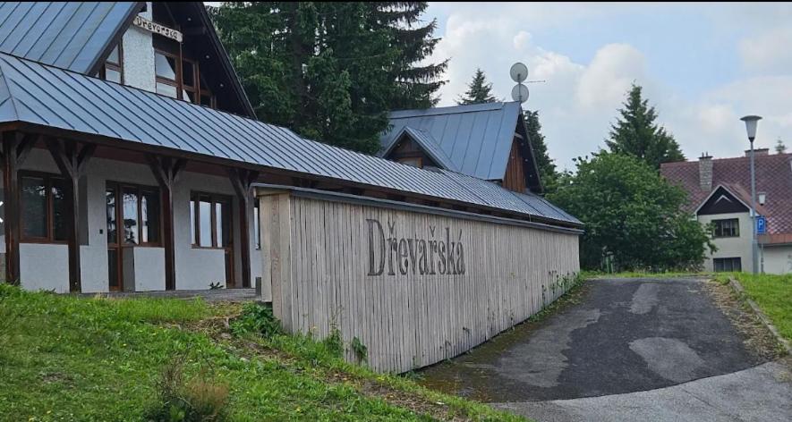 a building with writing on the side of it at Apartmány Dřevařská Benecko in Benecko