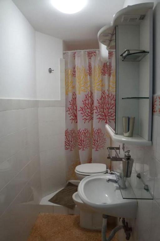 a bathroom with a sink and a toilet and a shower at SergioCasa con vista a mare in Castellammare di Stabia