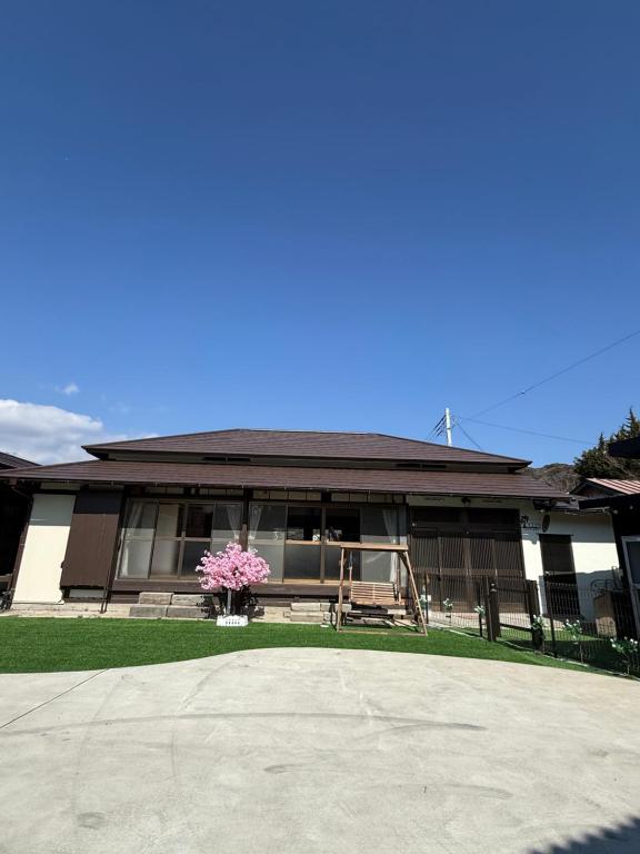 a house with a vase of flowers in front of it at yumigahama Eaglehouse in Minamiizu