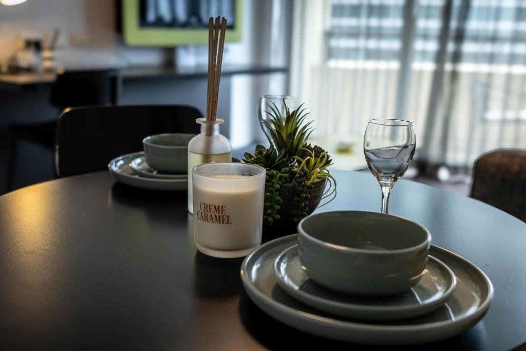a table with two plates and a glass of milk at 1 Bedroom Apartment In the heart of Parramatta CBD in Sydney
