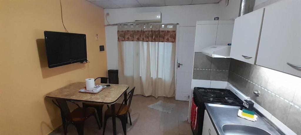 a small kitchen with a small table and a sink at Depto B in Rincon de los Sauces
