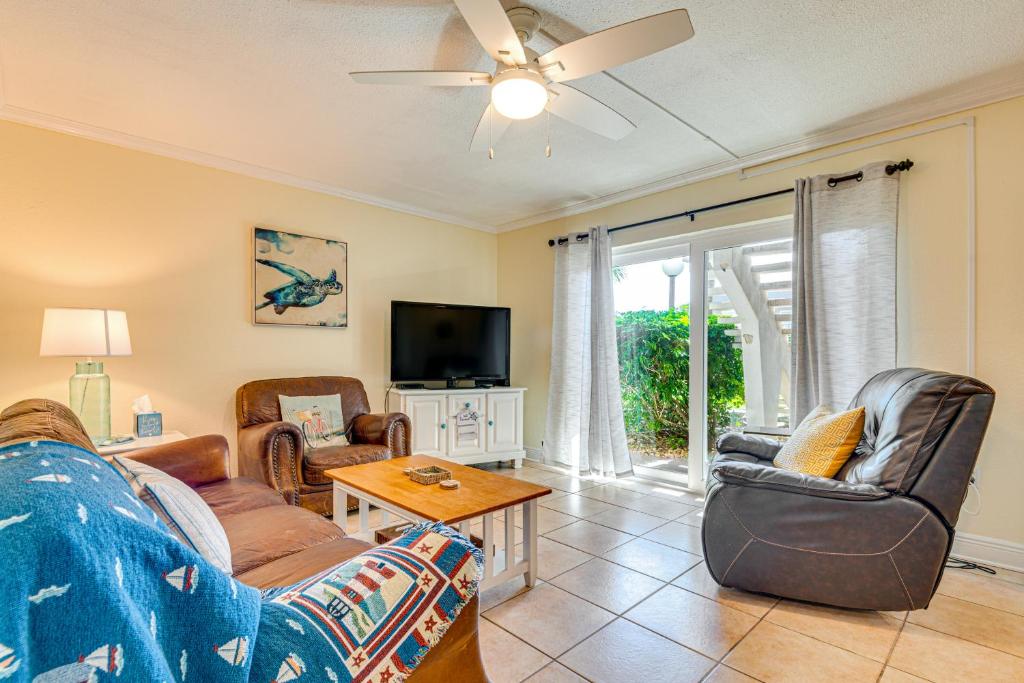 a living room with a couch and chairs and a tv at Cute Cocoa Beach Condo w/ Pool & Beach Access! in Cocoa Beach