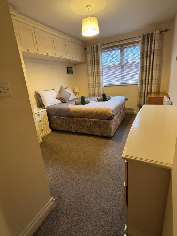 a small bedroom with a bed and a window at The Cozy Covert in Spondon, Derby in Derby