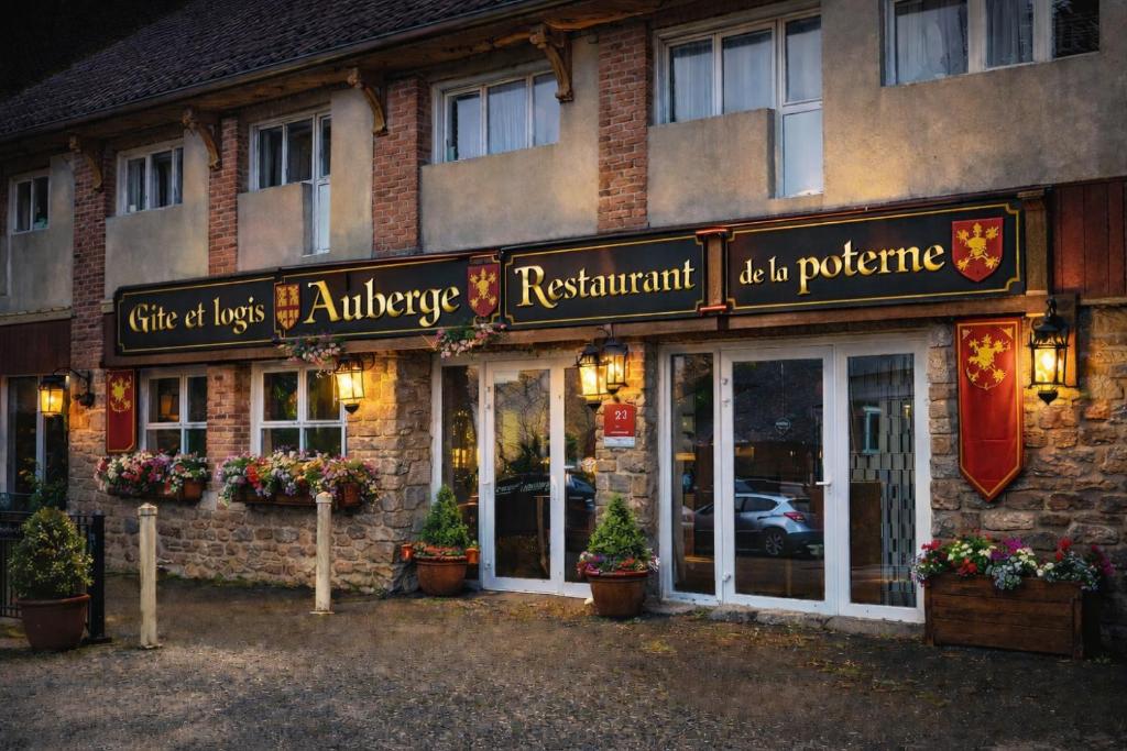 a building with a sign on the front of it at Auberge de la Poterne in Moncontour