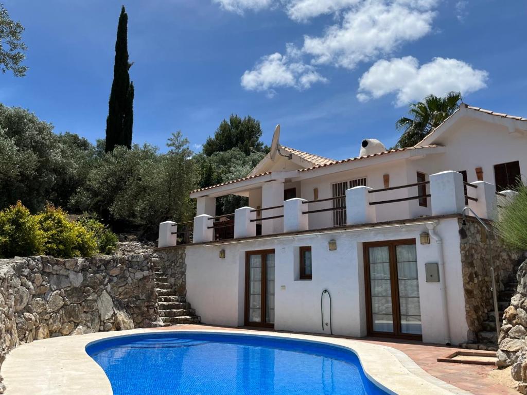 a house with a swimming pool in front of it at Casa Olivo in Casarabonela