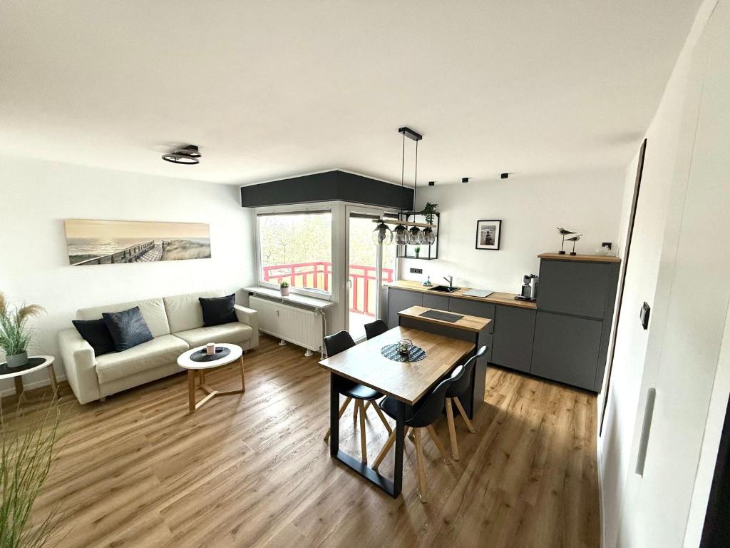 a living room with a couch and a table at Terrassenhaus, FeWo 45 in Duhnen