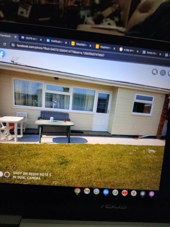 a computer screen with a picture of a house at 477 California Sands Chalets in Scratby