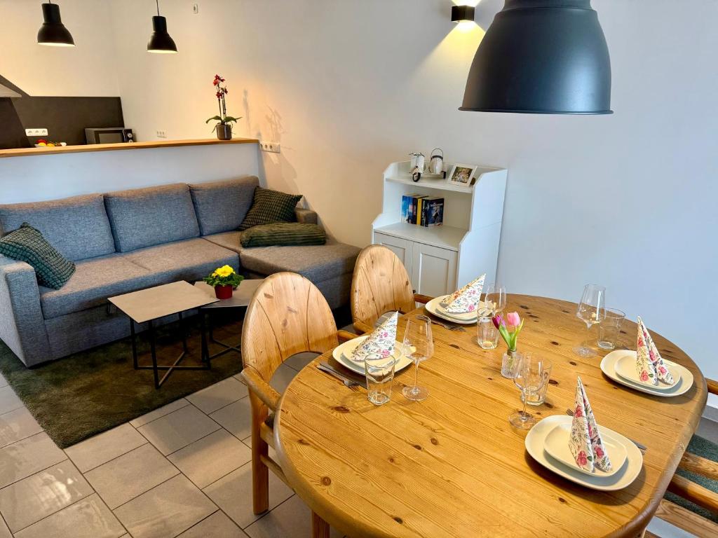 a living room with a wooden table and a couch at FeWo Gretl Stauden in Walkertshofen
