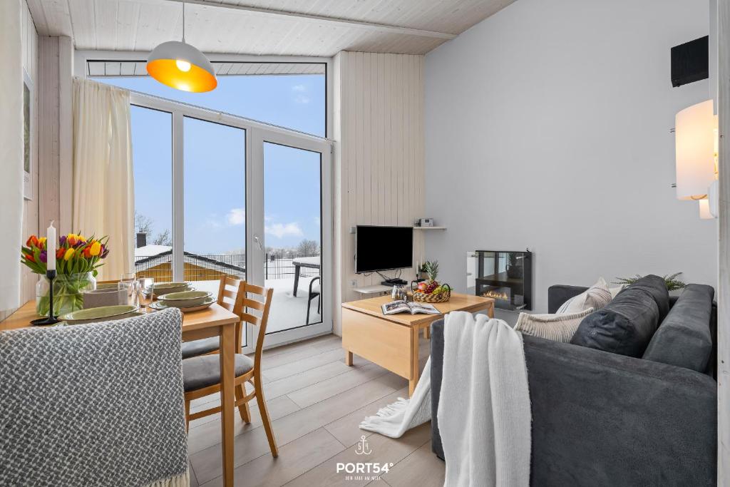 a living room with a couch and a table at Ferienhaus Bergoase - Sankt Andreasberg im Harz in Sankt Andreasberg