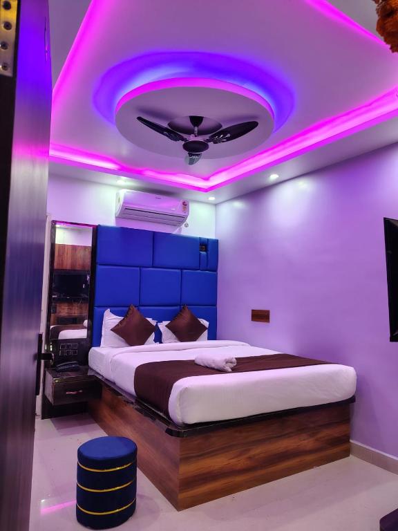 a bedroom with a bed with a purple lighting at Hotel Midnight in Muzaffarpur