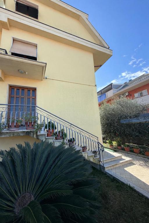 a house with a balcony and a plant in front of it at Sun Beach in San Benedetto del Tronto