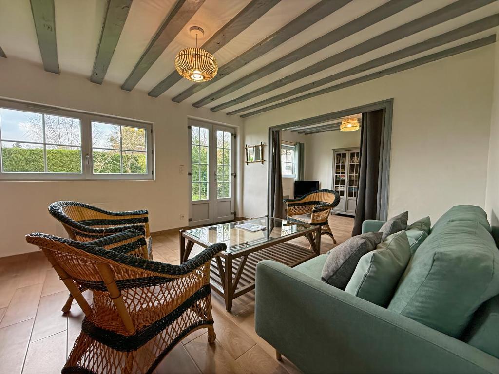 a living room with a couch and a table at Le Domaine de l'Ormurion in Sourdun