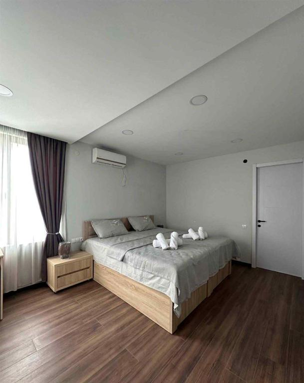a bedroom with a large bed with white pillows at Nebi Winery in Chʼardakhi