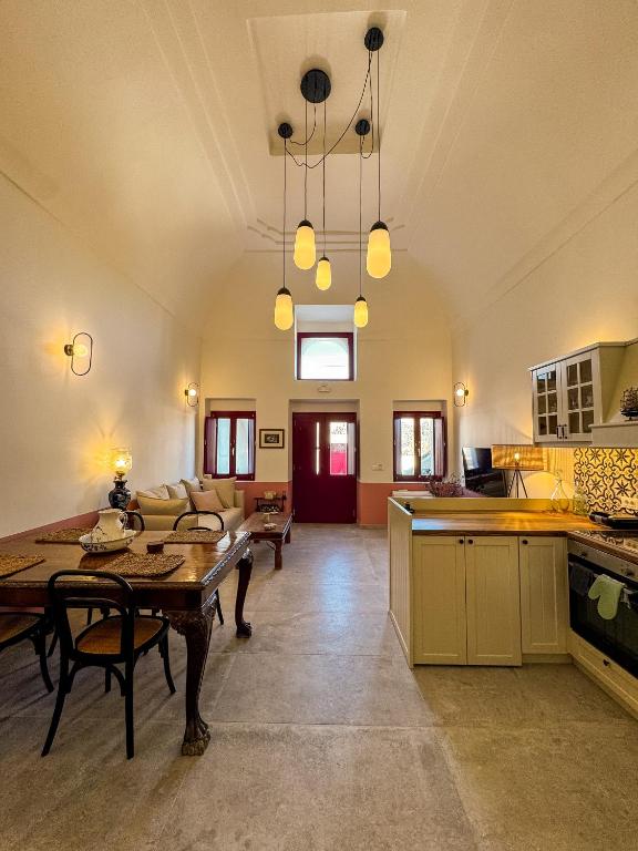 a kitchen and living room with a table and chairs at Arbarorisa Traditional Suites in Mesaria