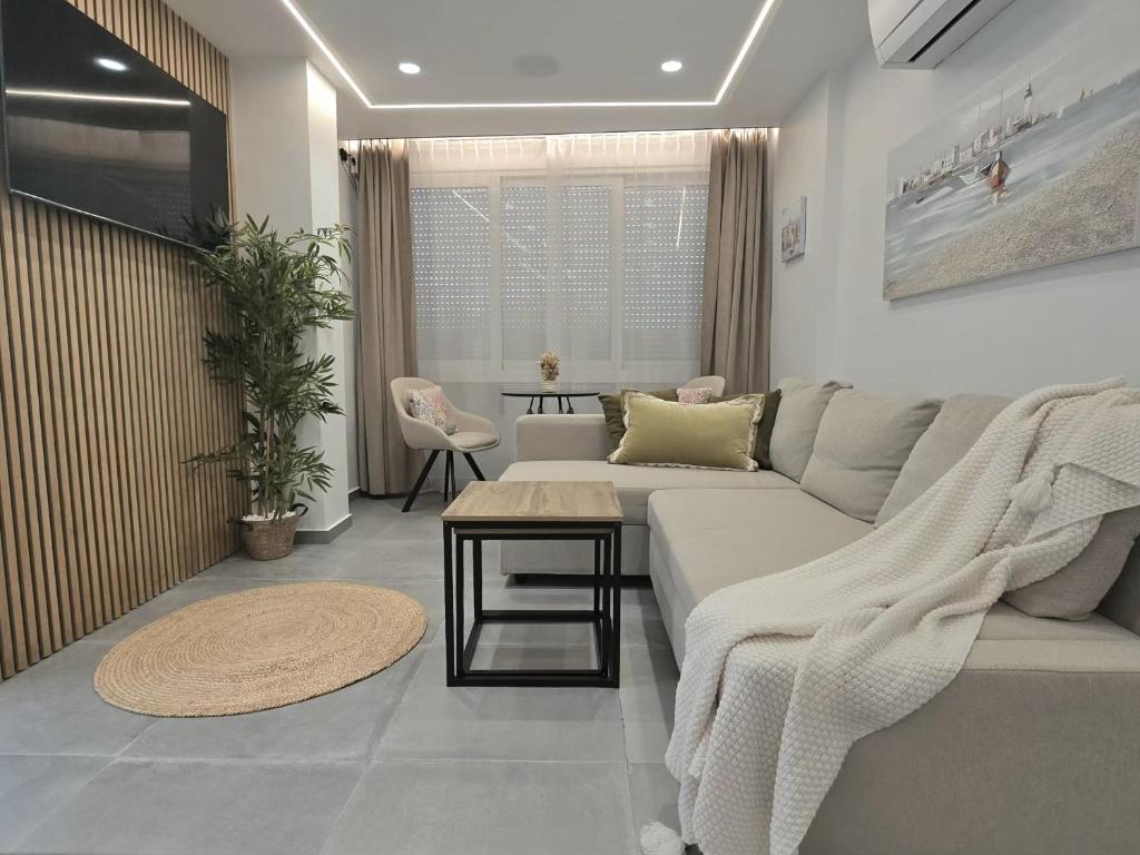 a living room with a couch and a table at Smart Space in La Mata