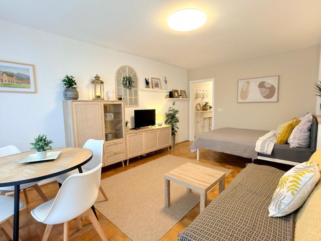 a living room with a bed and a table at Wohlfühl Apartment Bad Reichenhall nahe Salzburg in Bad Reichenhall