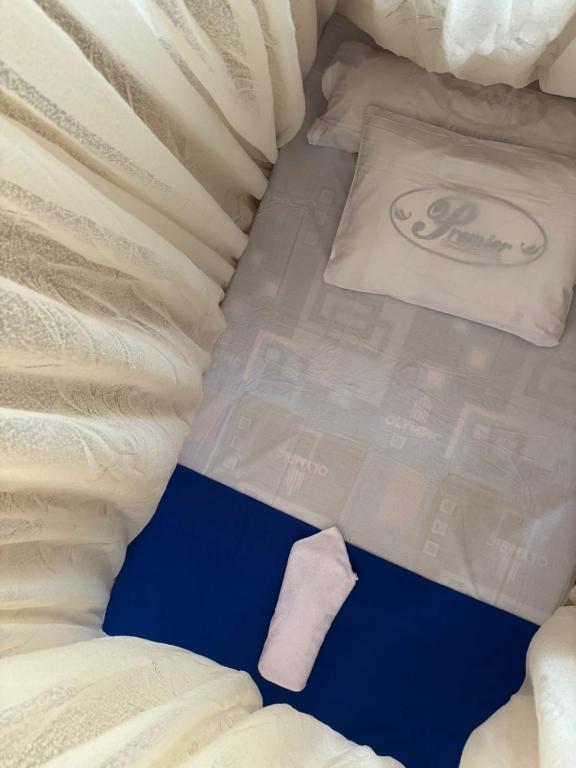 a close up of a bed with a pillow on it at Ina Homestay in Mios Besar
